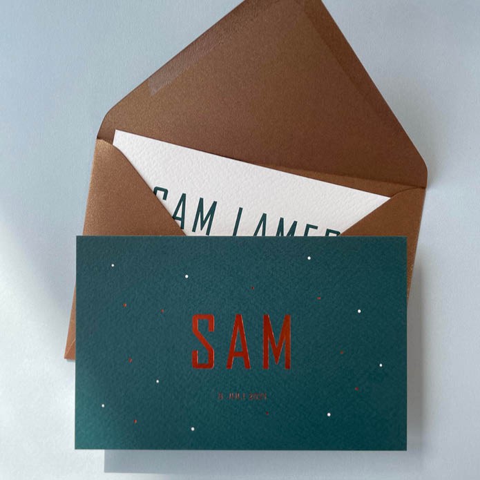 Petrol geboortekaartje met koper stipjes op de voorkant